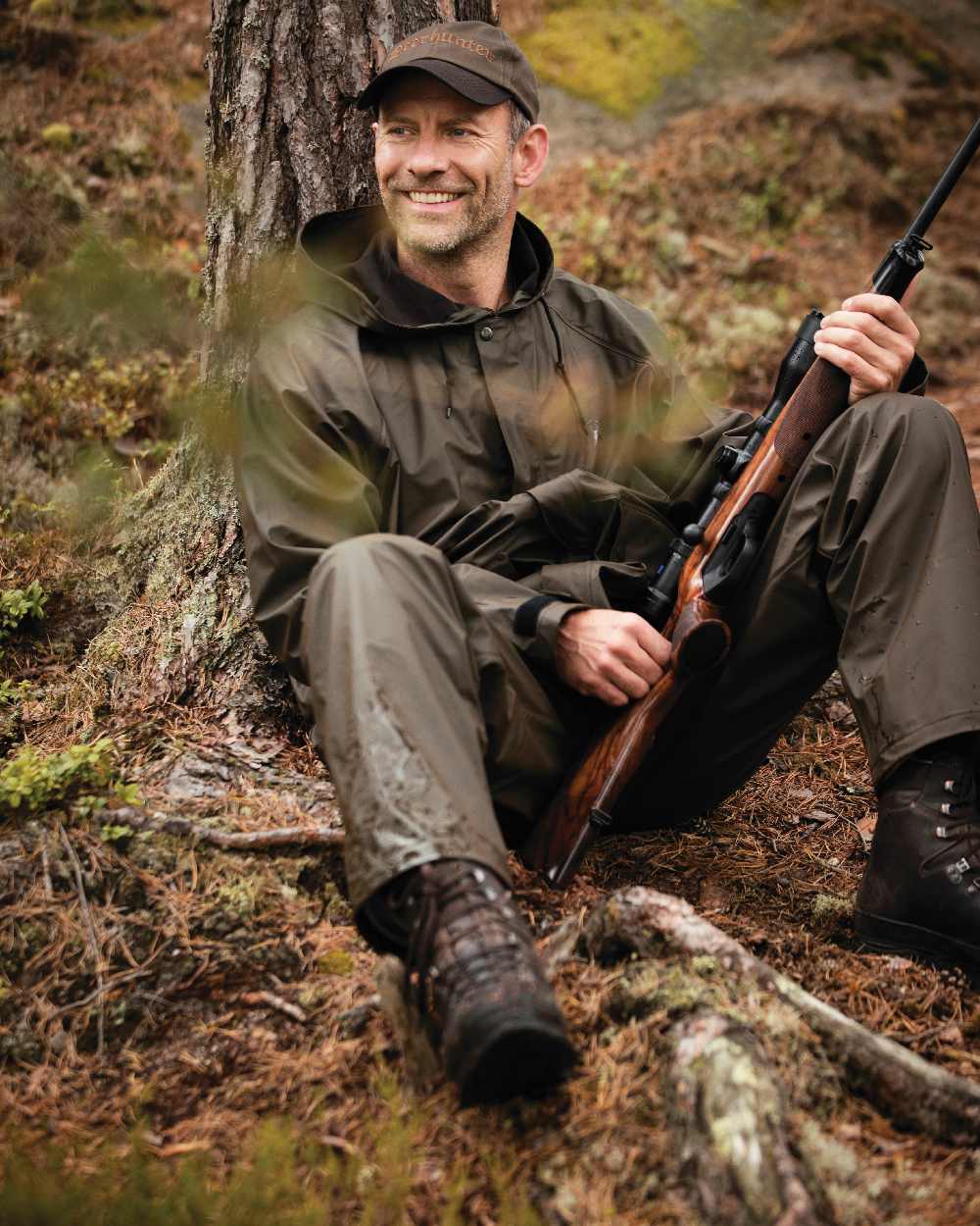 Art Green coloured Deerhunter Hurricane Rain Jacket on forest background #colour_art-green