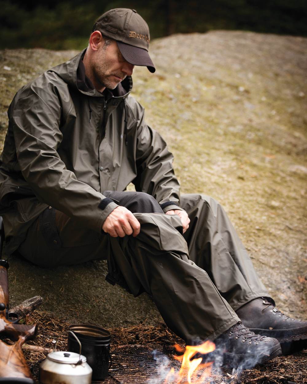 Art Green coloured Deerhunter Hurricane Rain Trousers on rock background #colour_art-green