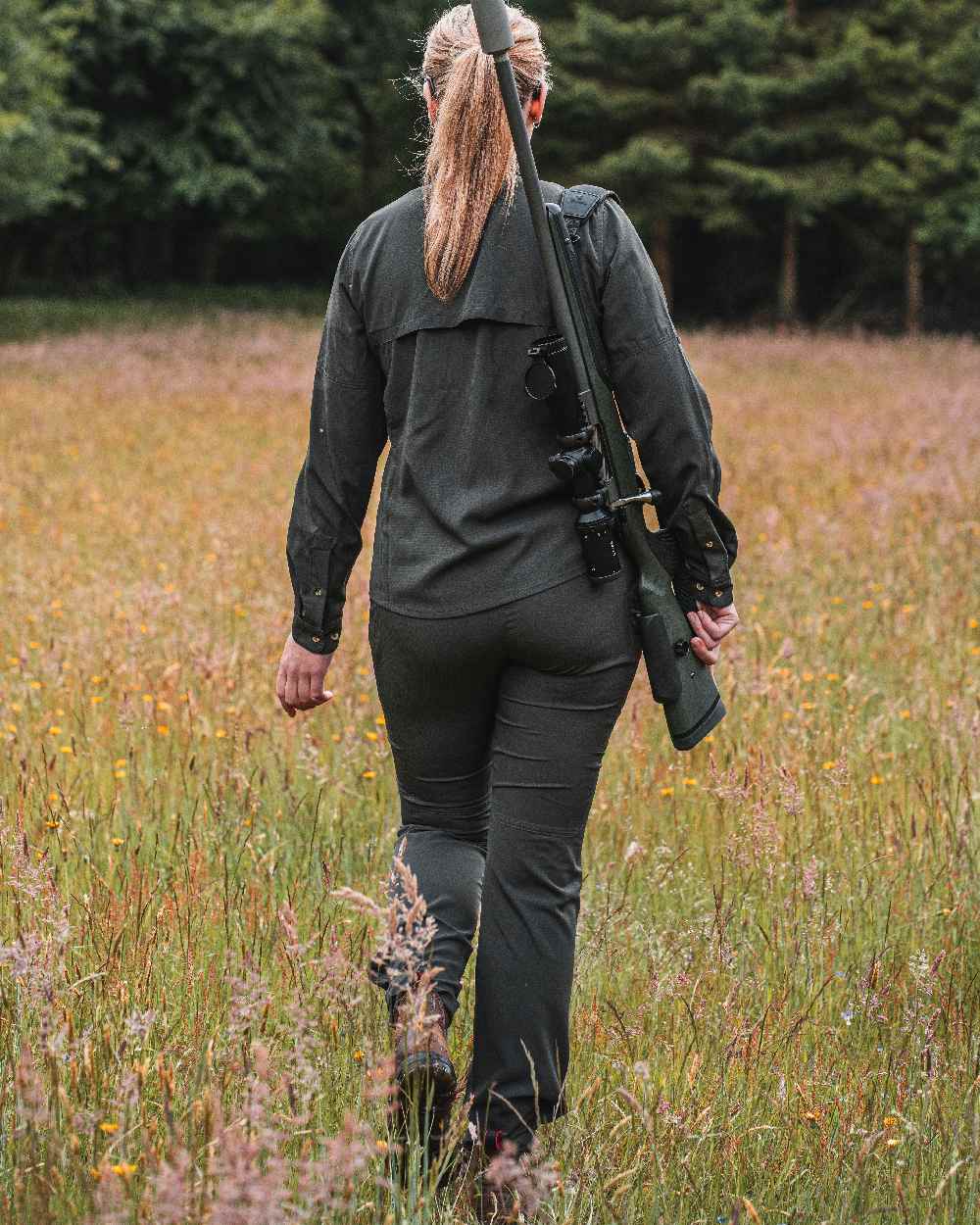 Forest Green coloured Deerhunter Lady Canopy Trousers on grassy background #colour_forest-green