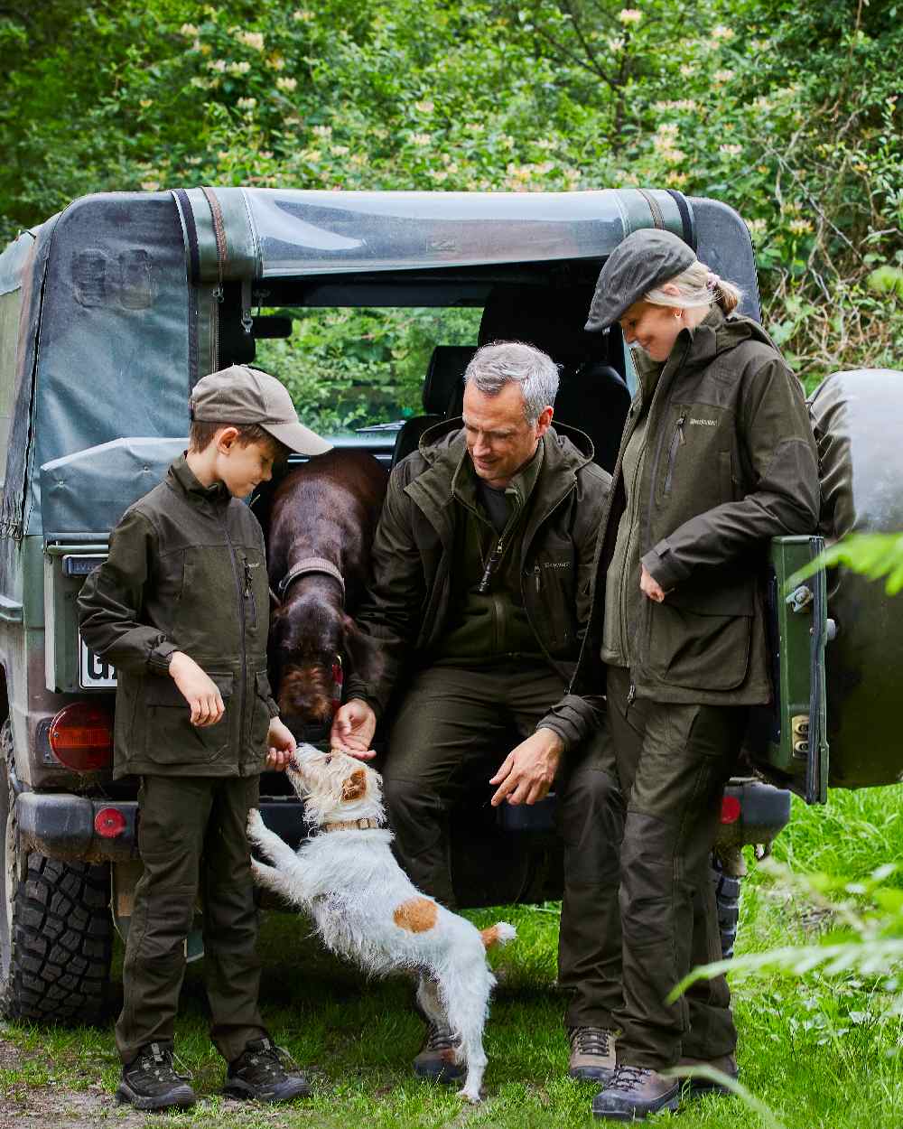 Olive Night Melange coloured Deerhunter Lady Chasse Trousers on jeep background #colour_olive-night-melange