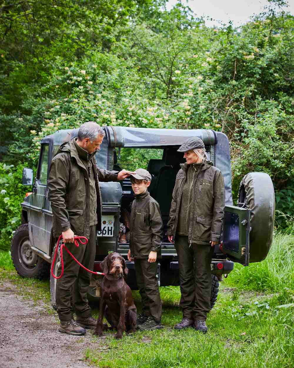 Olive Night Melange coloured Deerhunter Lady Chasse Trousers on jeep background #colour_olive-night-melange