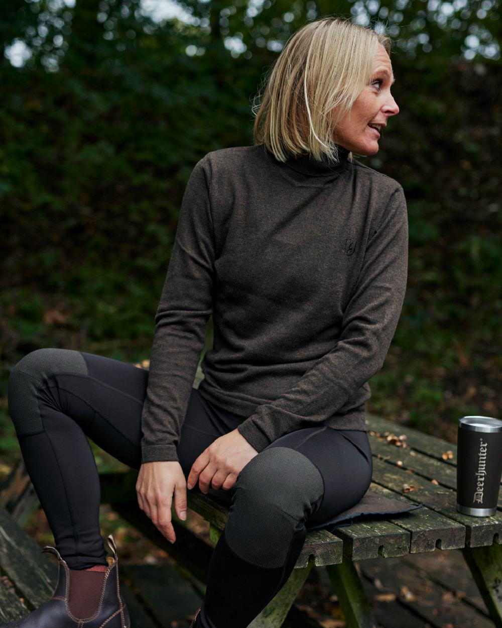 Dark Elm coloured Deerhunter Lady Darlington Roll Neck on forest background #colour_dark-elm
