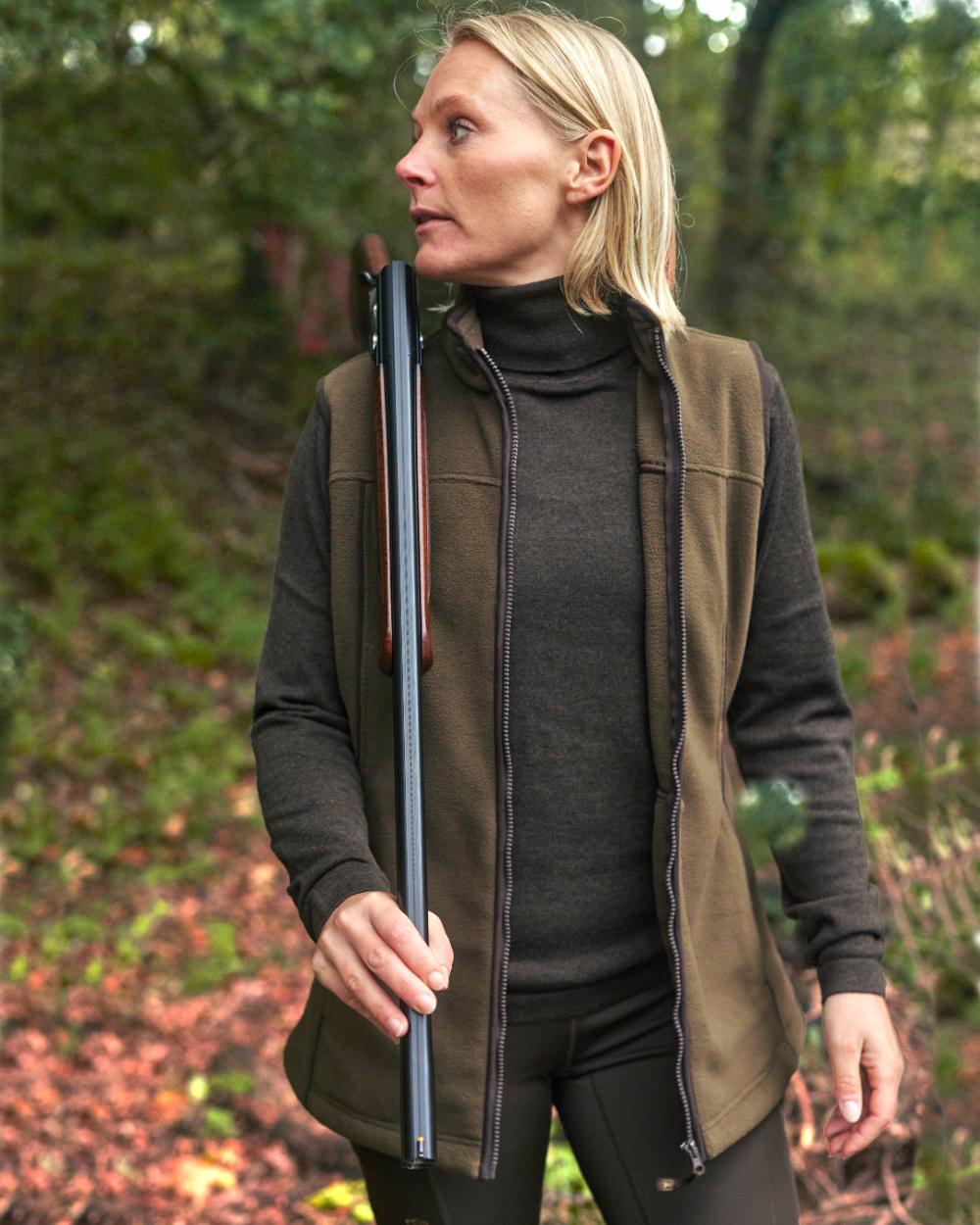 Tarmac Green Coloured Deerhunter Lady Eagle Fleece Waistcoat on forest background #colour_tarmac-green