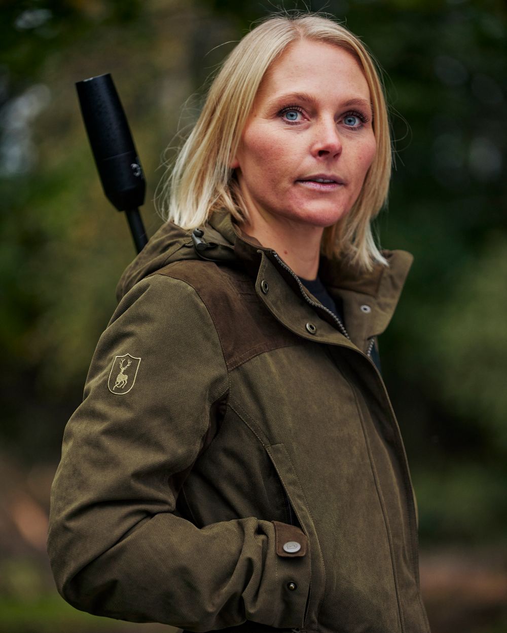 Tarmac Green Coloured Deerhunter Lady Eagle Jacket on blurry background #colour_tarmac-green
