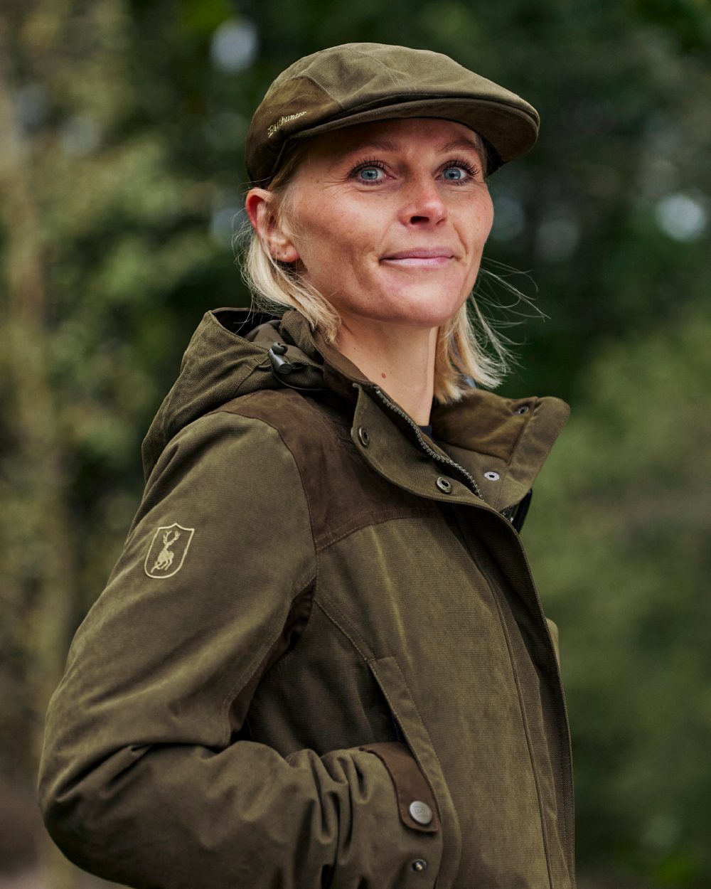 Tarmac Green Coloured Deerhunter Lady Eagle Jacket on blurry background #colour_tarmac-green