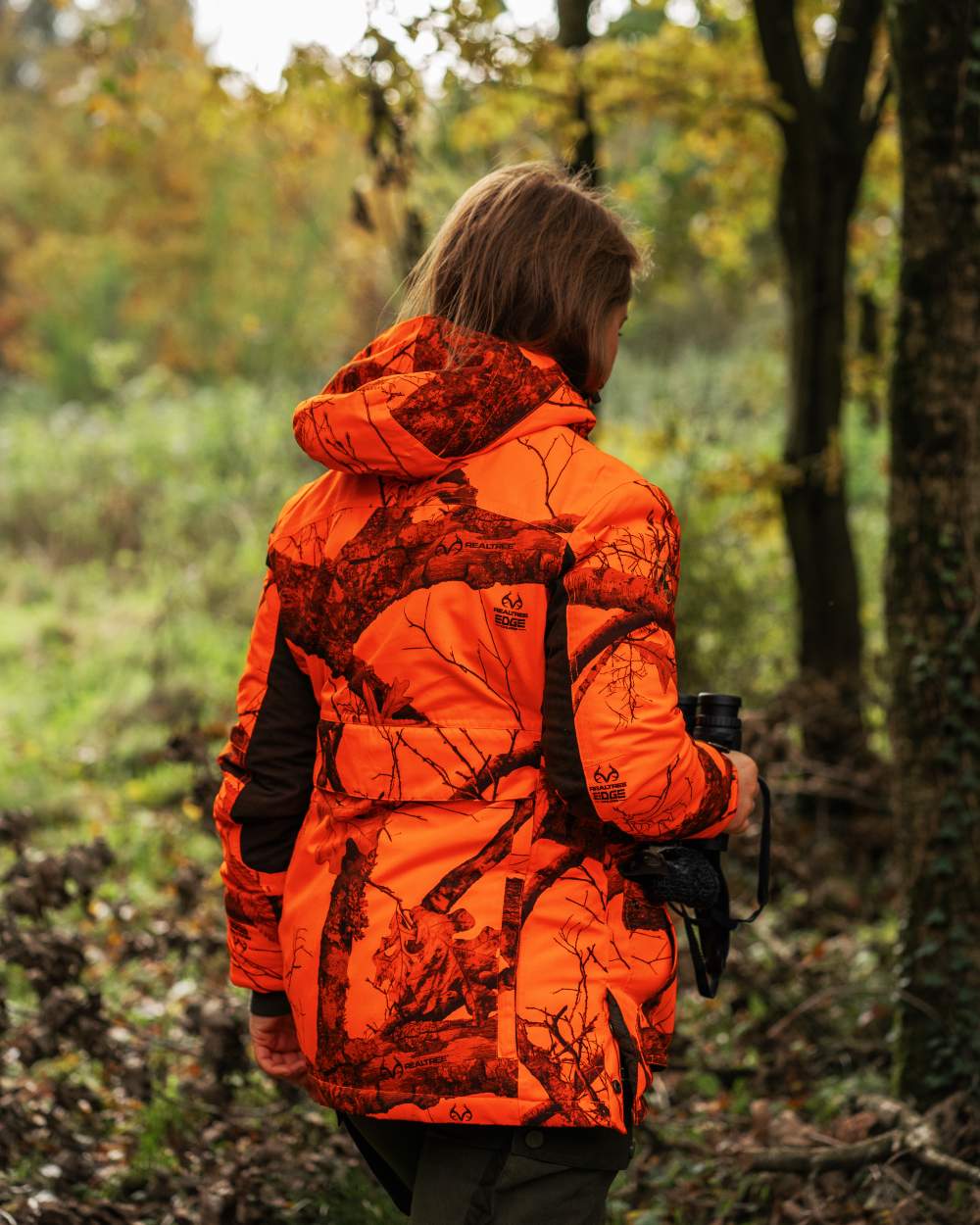 Realtree Edge Orange coloured Deerhunter Lady Eagle Winter Jacket  on forest background #colour_realtree-edge-orange