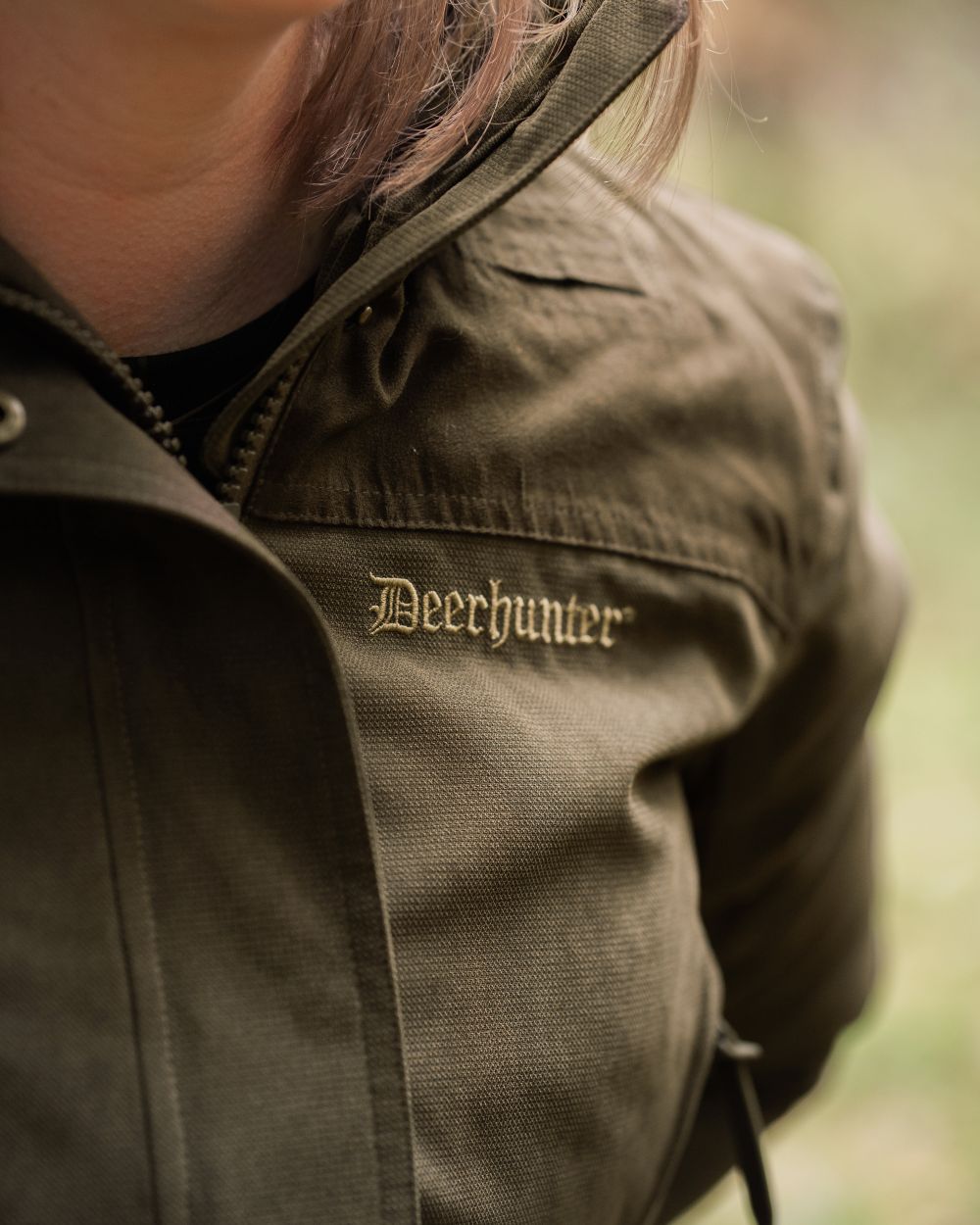 Tarmac Green coloured Deerhunter Lady Eagle Winter Jacket on blurry background #colour_tarmac-green