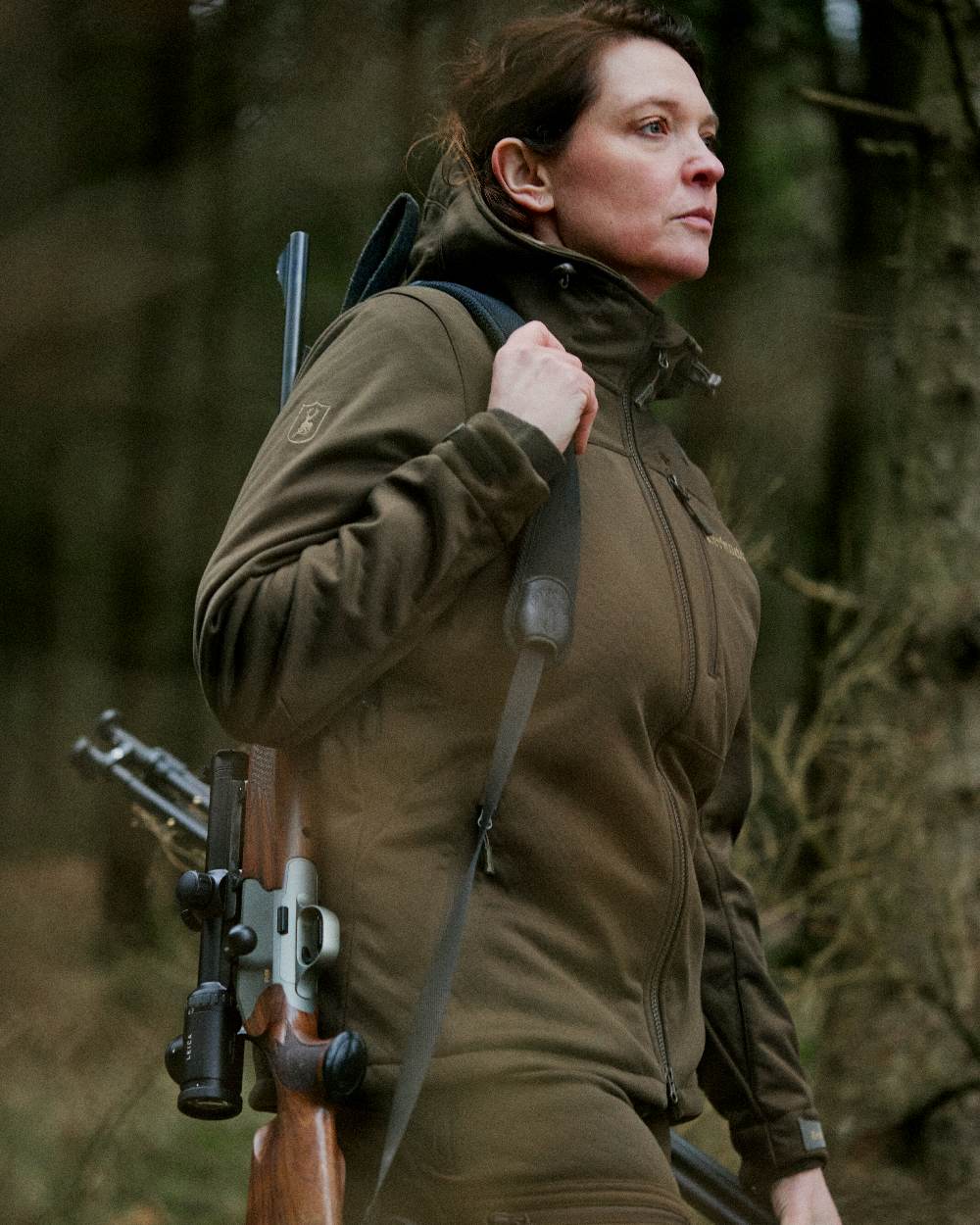 Art Green coloured Deerhunter Lady Excape Softshell Jacket on blurry background #colour_art-green