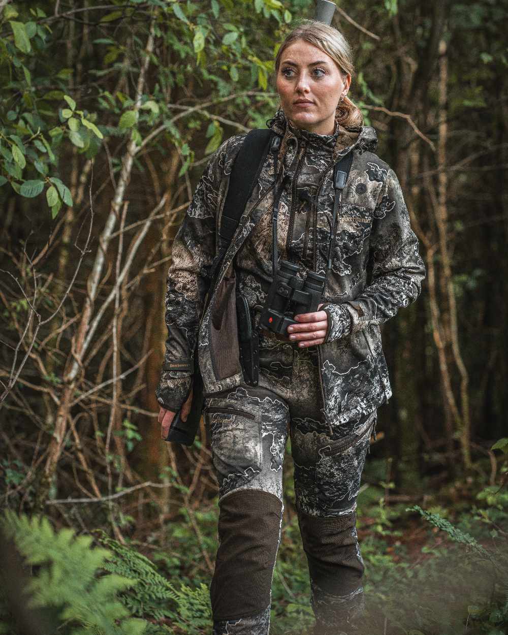 Realtree Excape coloured Deerhunter Lady Excape Softshell Jacket on forest background #colour_realtree-excape