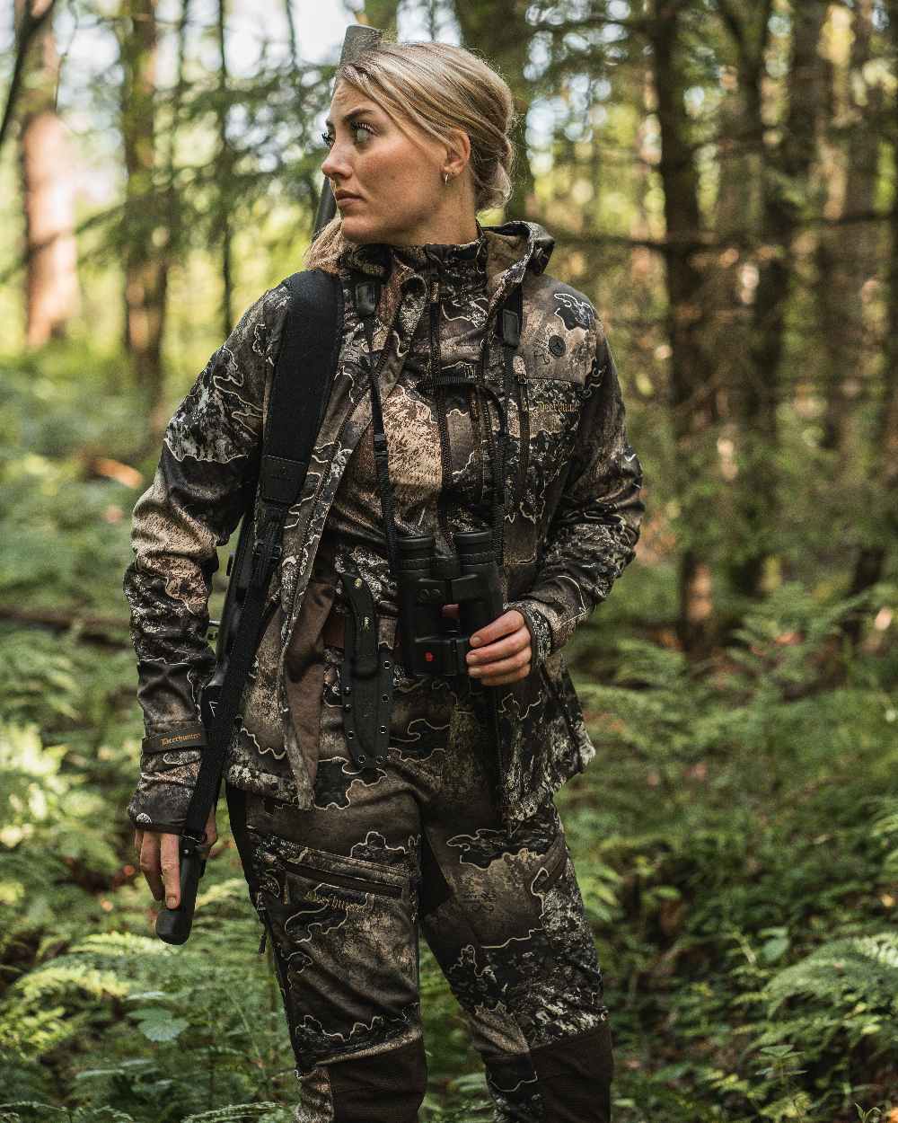 Realtree Excape coloured Deerhunter Lady Excape Softshell Jacket on forest background #colour_realtree-excape