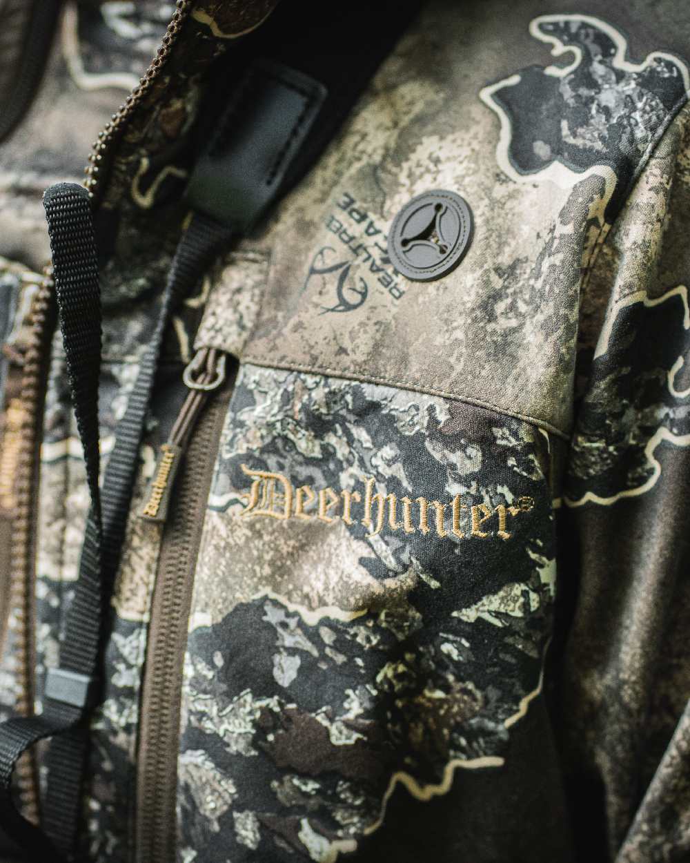 Realtree Excape coloured Deerhunter Lady Excape Softshell Jacket on blurry background #colour_realtree-excape