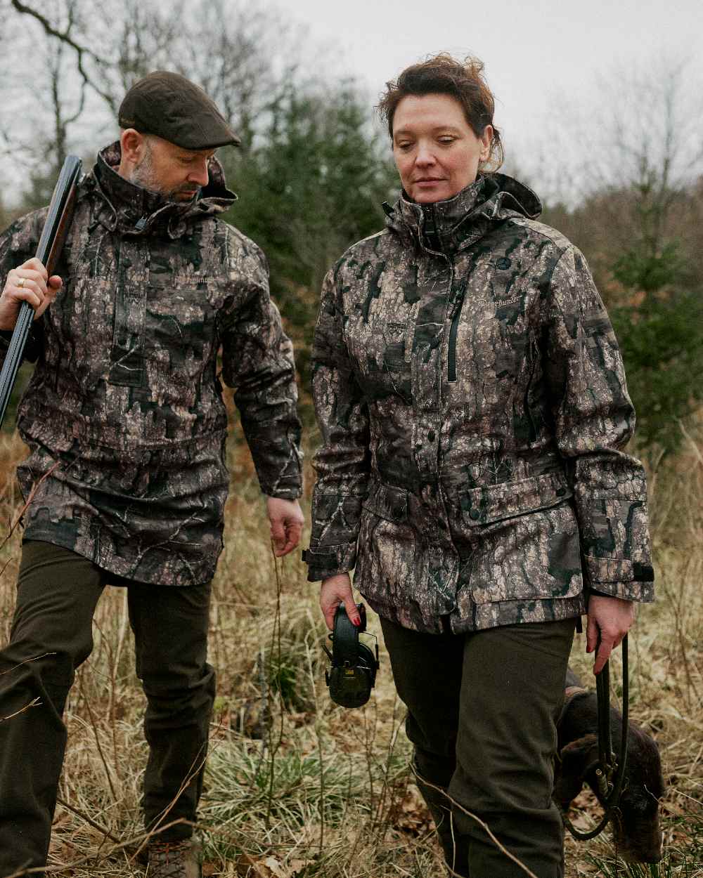 Peat coloured Deerhunter Lady Gabby Waterproof Boot Trousers on forest background #colour_peat