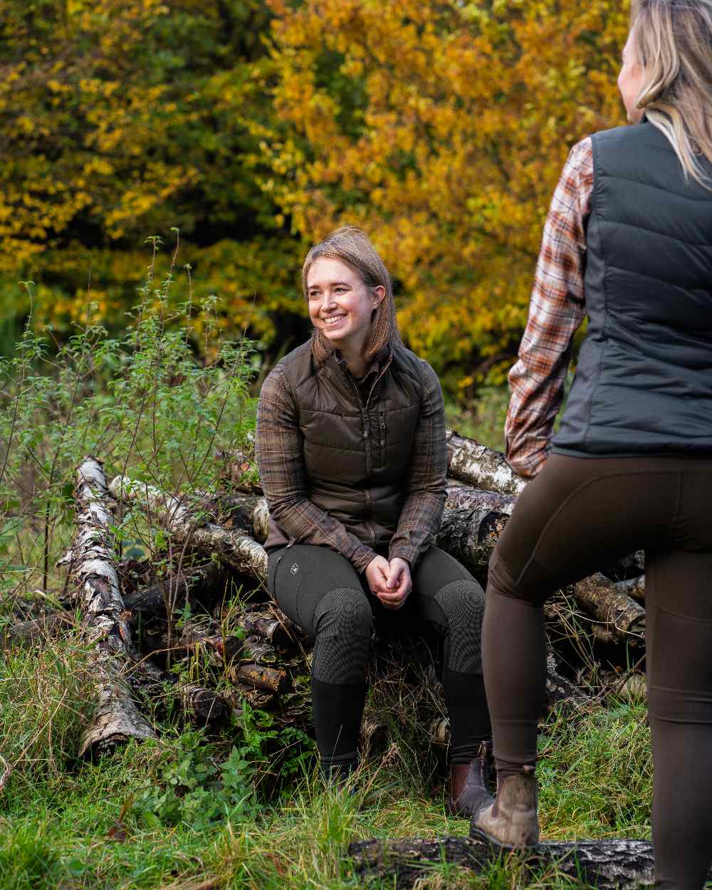 Wood Coloured Deerhunter Lady Heat Padded Waistcoat on forest background #colour_wood