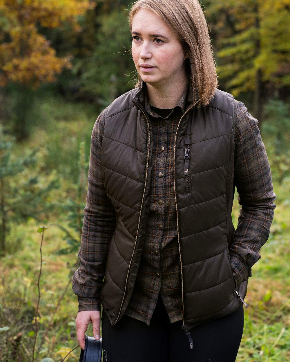 Wood Coloured Deerhunter Lady Heat Padded Waistcoat on forest background #colour_wood
