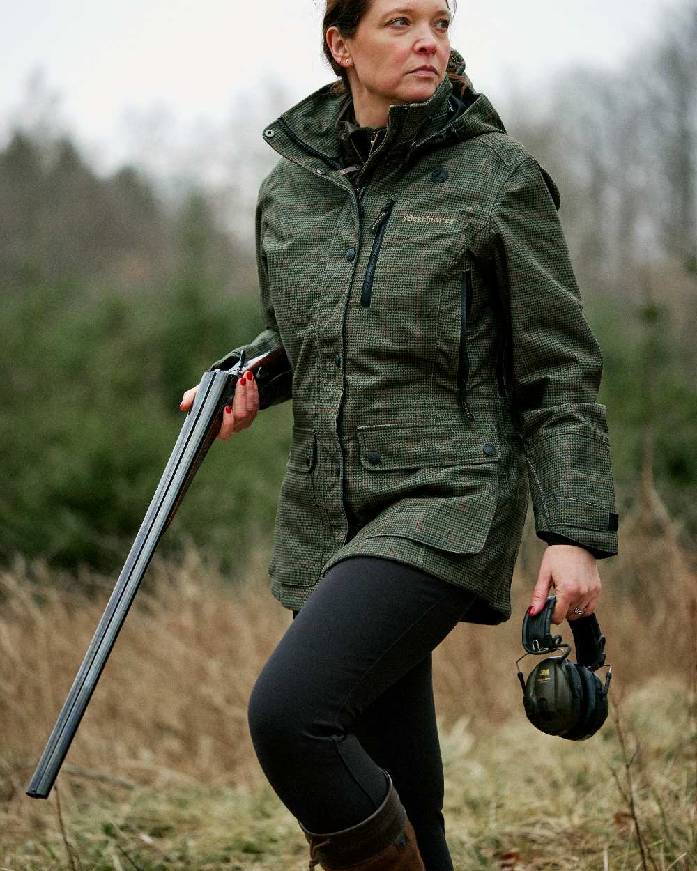 Black coloured Deerhunter Lady Hunting Tights on grassy background #colour_black