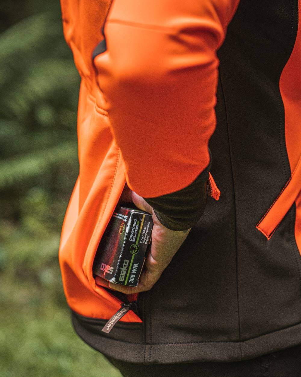 Orange coloured Deerhunter Lady Roja Softshell Jacket on blurry background #colour_orange