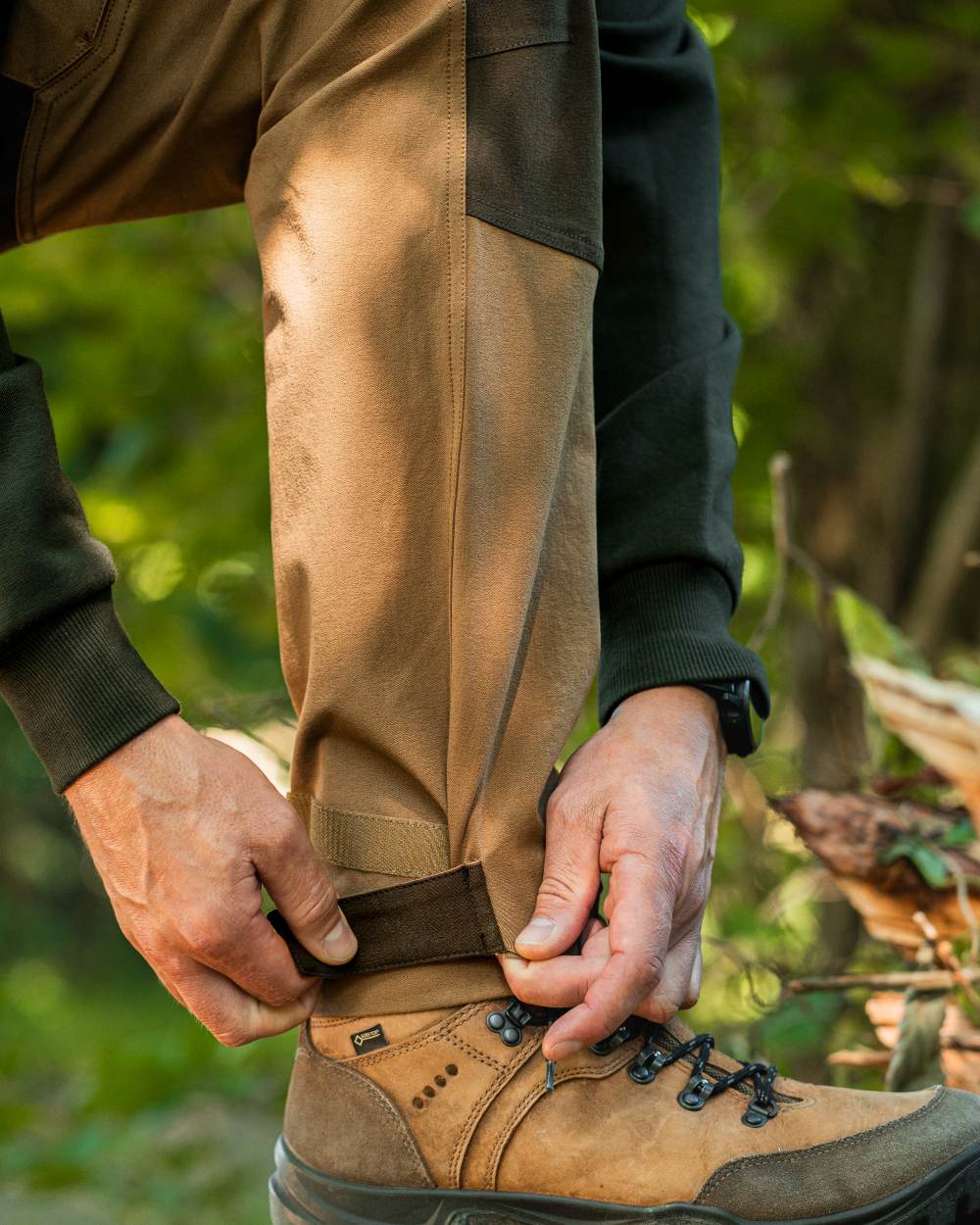 Butternut Fallen Leaf coloured Deerhunter Lady Sarek Full Stretch Trousers on forest background #colour_butternut-fallen-leaf