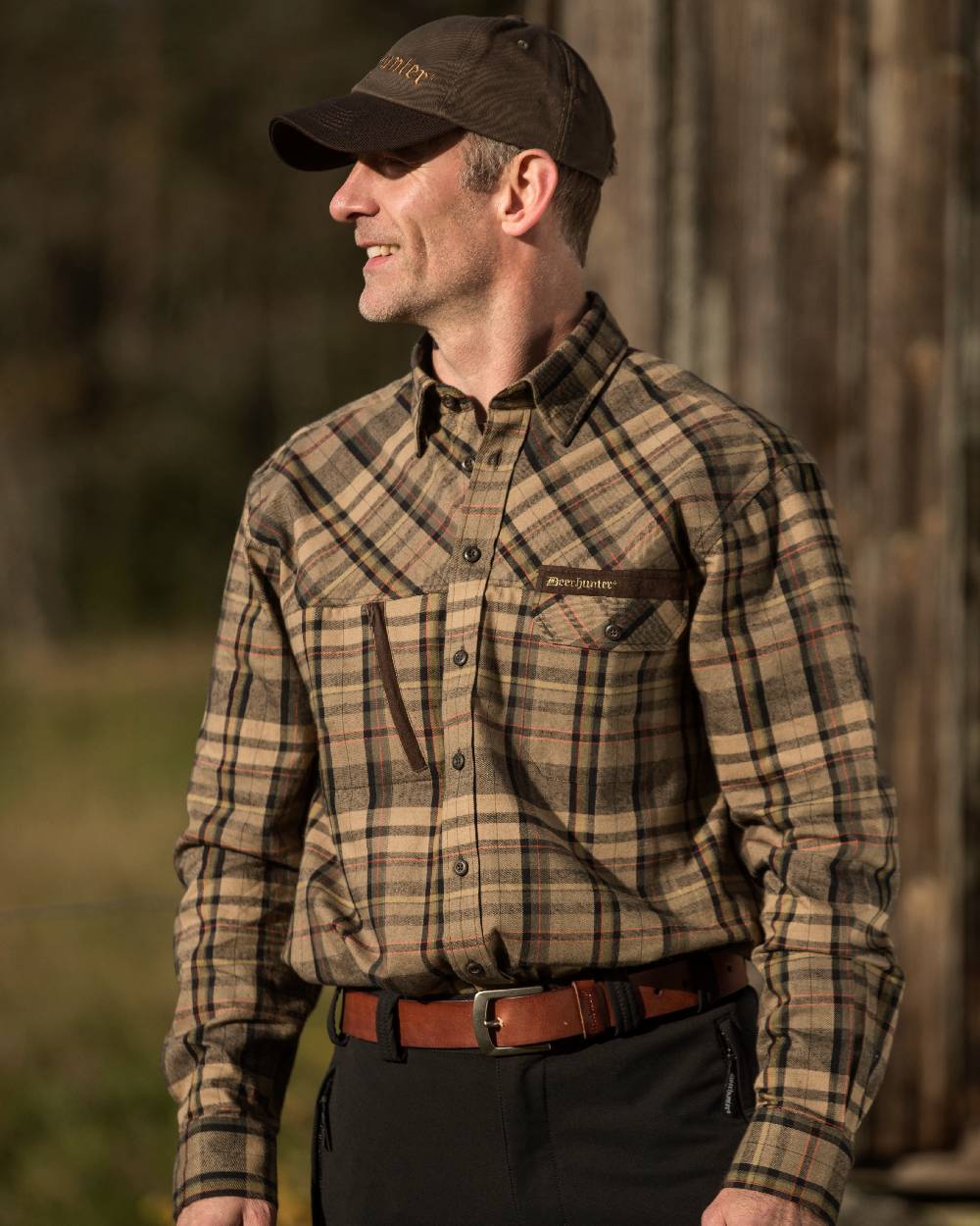 Cognac Brown coloured Deerhunter Leather Belt on tree background #colour_cognac-brown