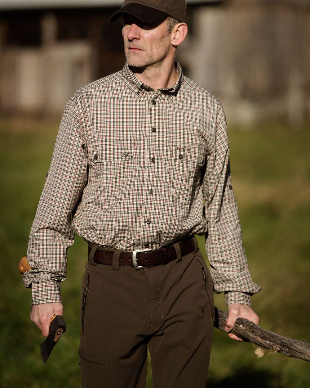 Dark Brown coloured Deerhunter Leather Belt on blurry background #colour_dark-brown