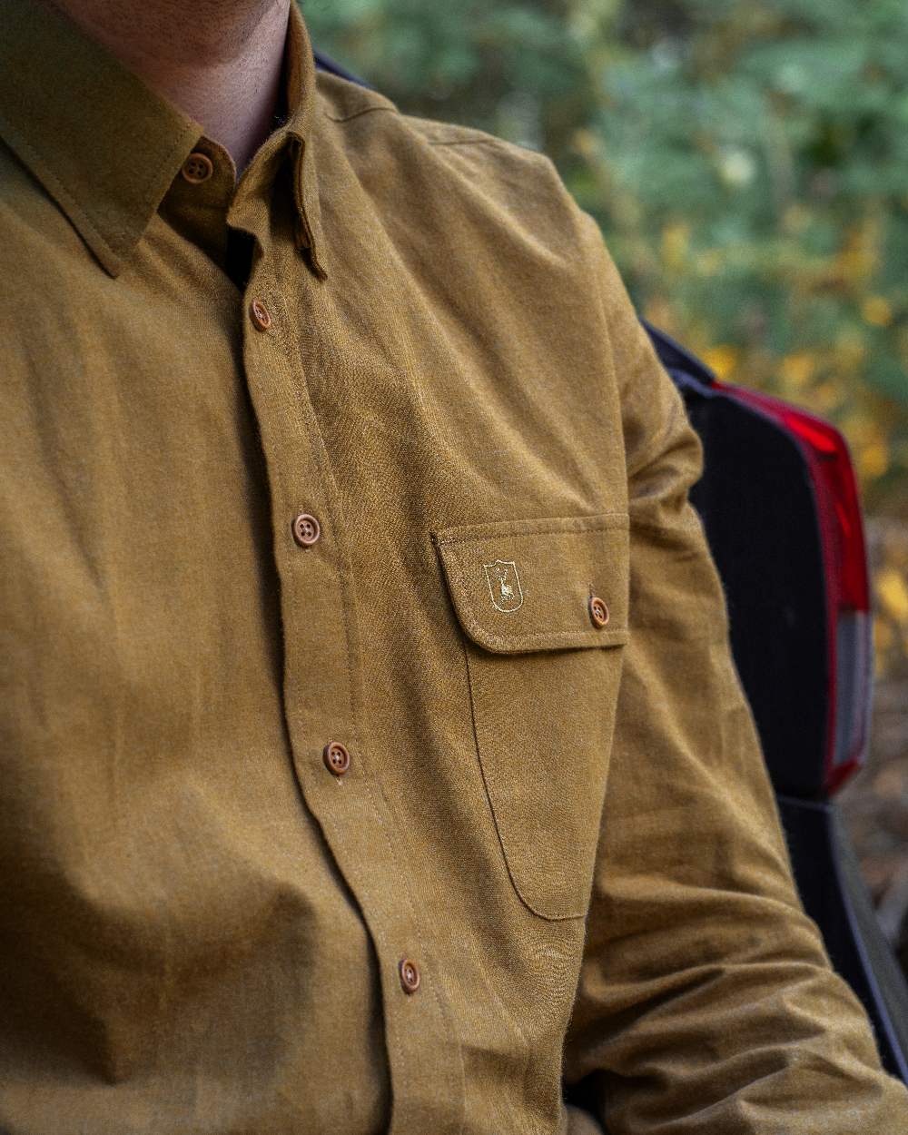 Ocher Brown coloured Deerhunter Liam Cotton Shirt on blurry background #colour_ocher-brown
