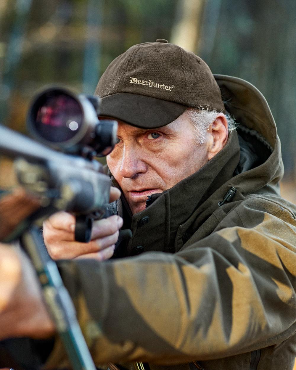 Peat Coloured Deerhunter PRO Gamekeeper Jacket on blurry background #colour_peat