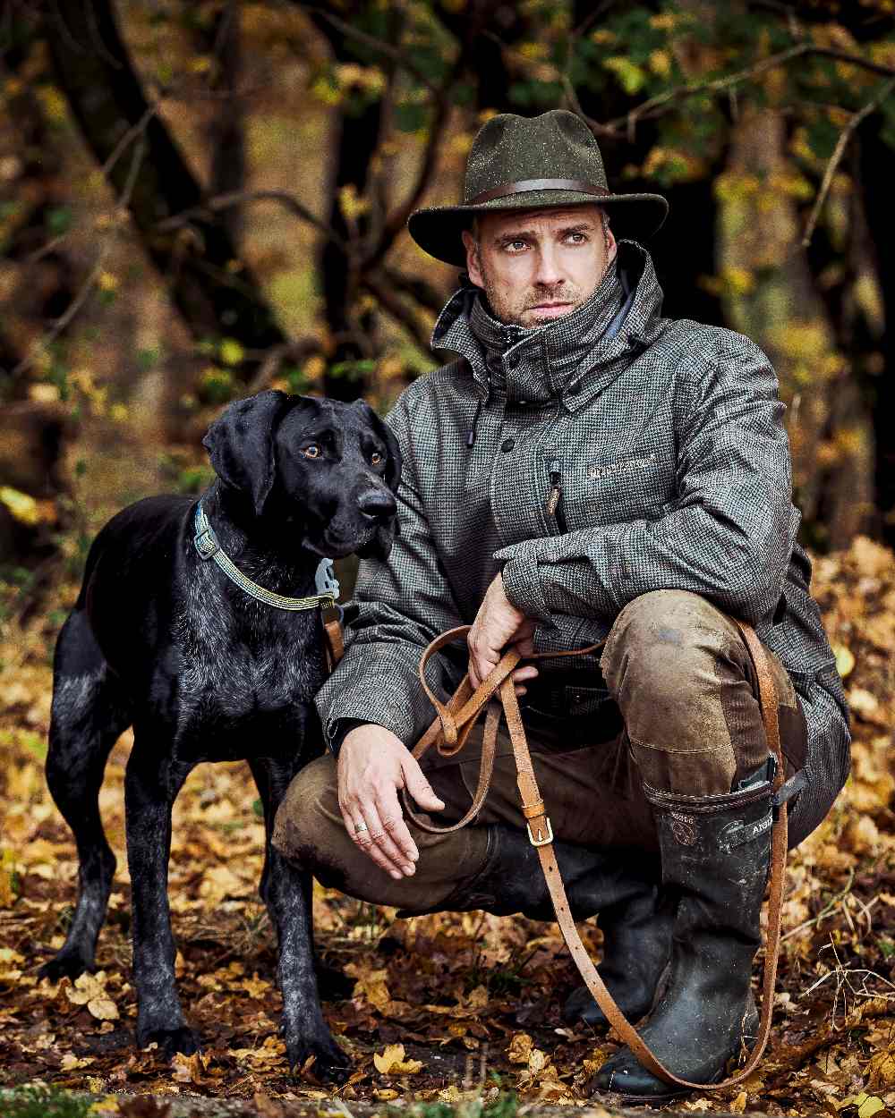 Turf Coloured Deerhunter PRO Gamekeeper Jacket on forest background #colour_turf