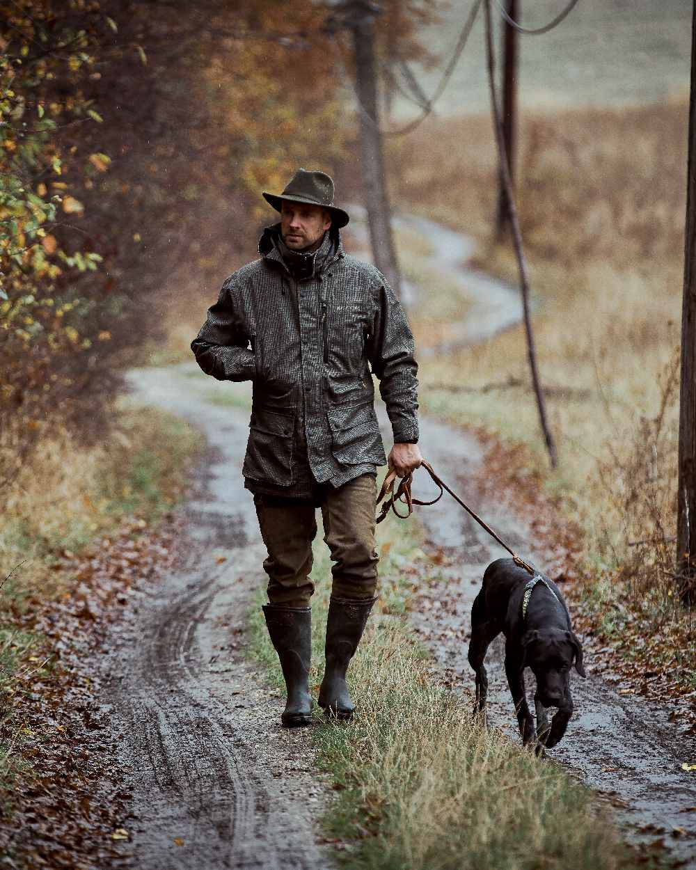 Turf Coloured Deerhunter PRO Gamekeeper Jacket on forest background #colour_turf