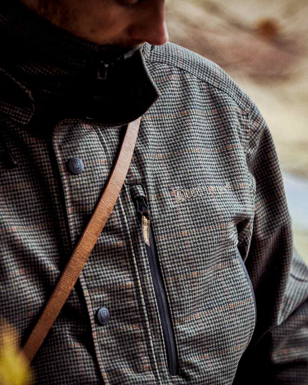 Turf Coloured Deerhunter PRO Gamekeeper Jacket on blurry background #colour_turf