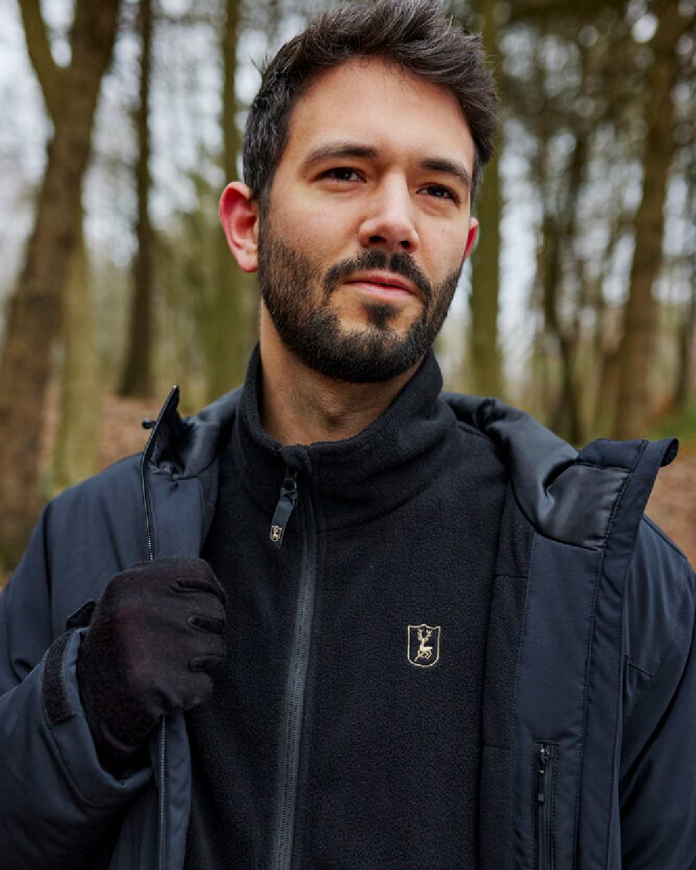Black Oak coloured Deerhunter Quinn Merino Gloves on forest background #colour_black-oak