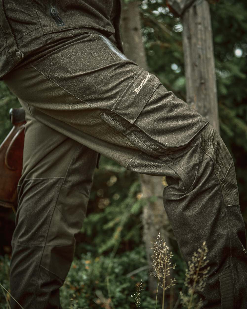 Elmwood coloured Deerhunter Ram Trousers on forest background #colour_elmwood