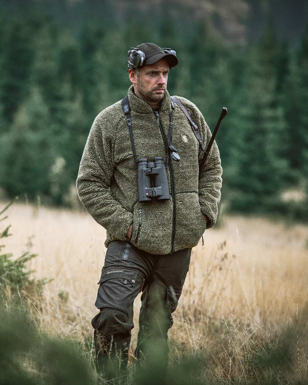 Elmwood coloured Deerhunter Ram Trousers on grassy background #colour_elmwood