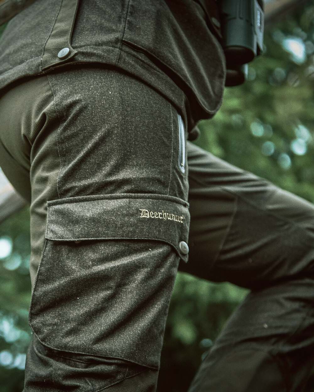 Elmwood coloured Deerhunter Ram Trousers on blurry background #colour_elmwood