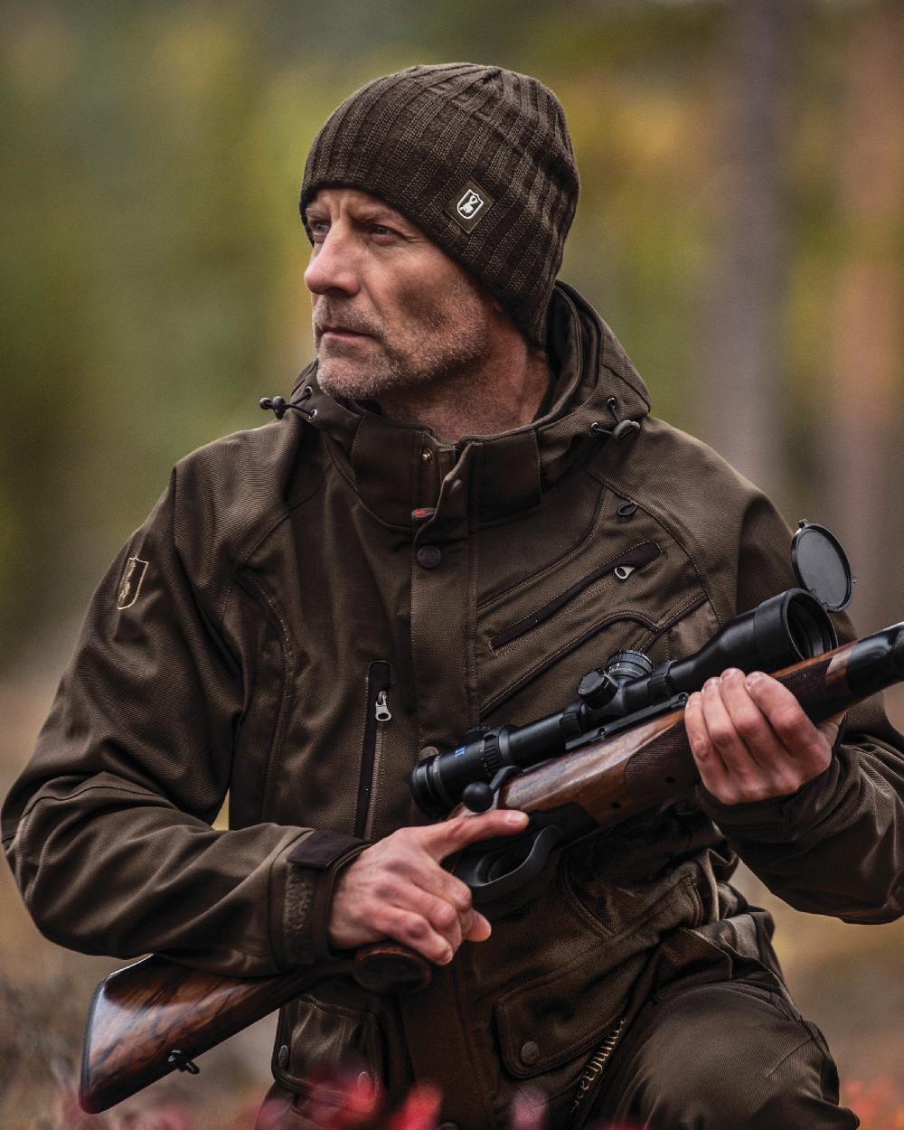 Beluga coloured Deerhunter Recon Knitted Beanie on forest background #colour_beluga