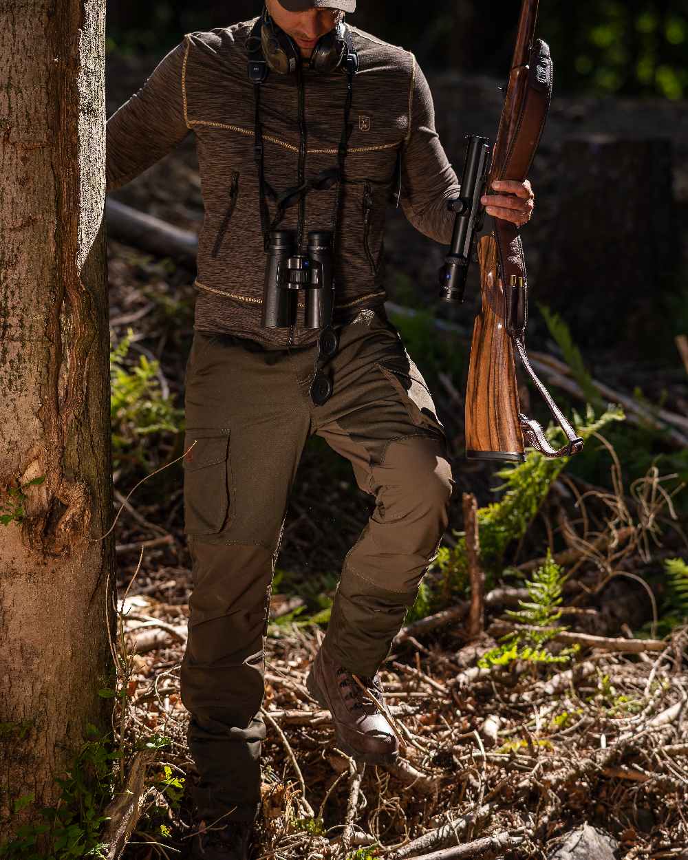 Adventure Green Coloured Deerhunter Rogaland Stretch Trousers on forest background #colour_adventure-green