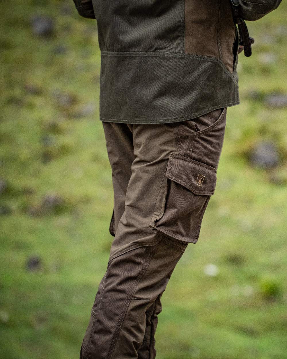 Fallen Leaf Coloured Deerhunter Rogaland Stretch Trousers on blurry background #colour_fallen-leaf