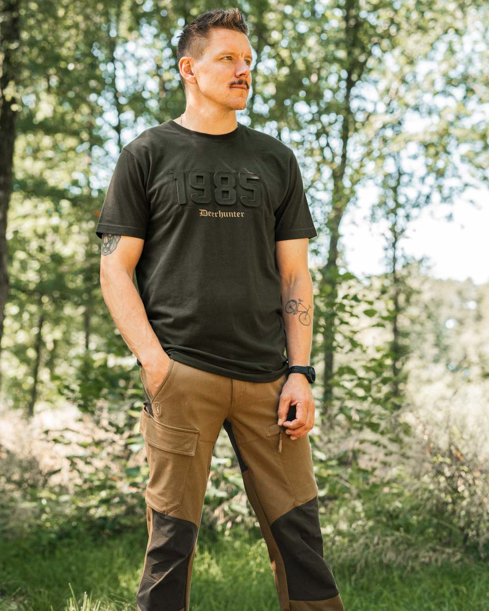 Butternut Fallen Leaf Black coloured Deerhunter Sarek Full Stretch Trousers on forest background #colour_butternut-fallen-leaf