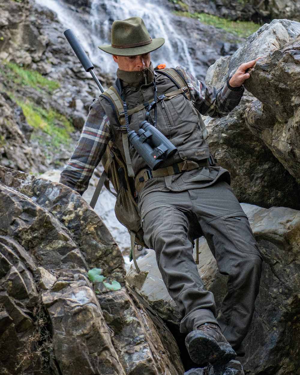 Palm Green coloured Deerhunter Strike Extreme Trousers on mountain background #colour_palm-green