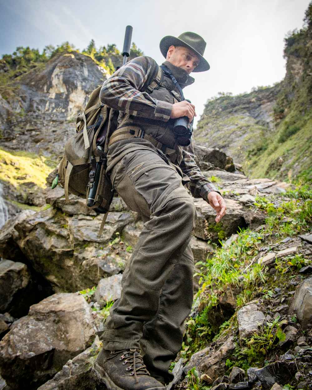 Palm Green coloured Deerhunter Strike Extreme Trousers on mountain background #colour_palm-green