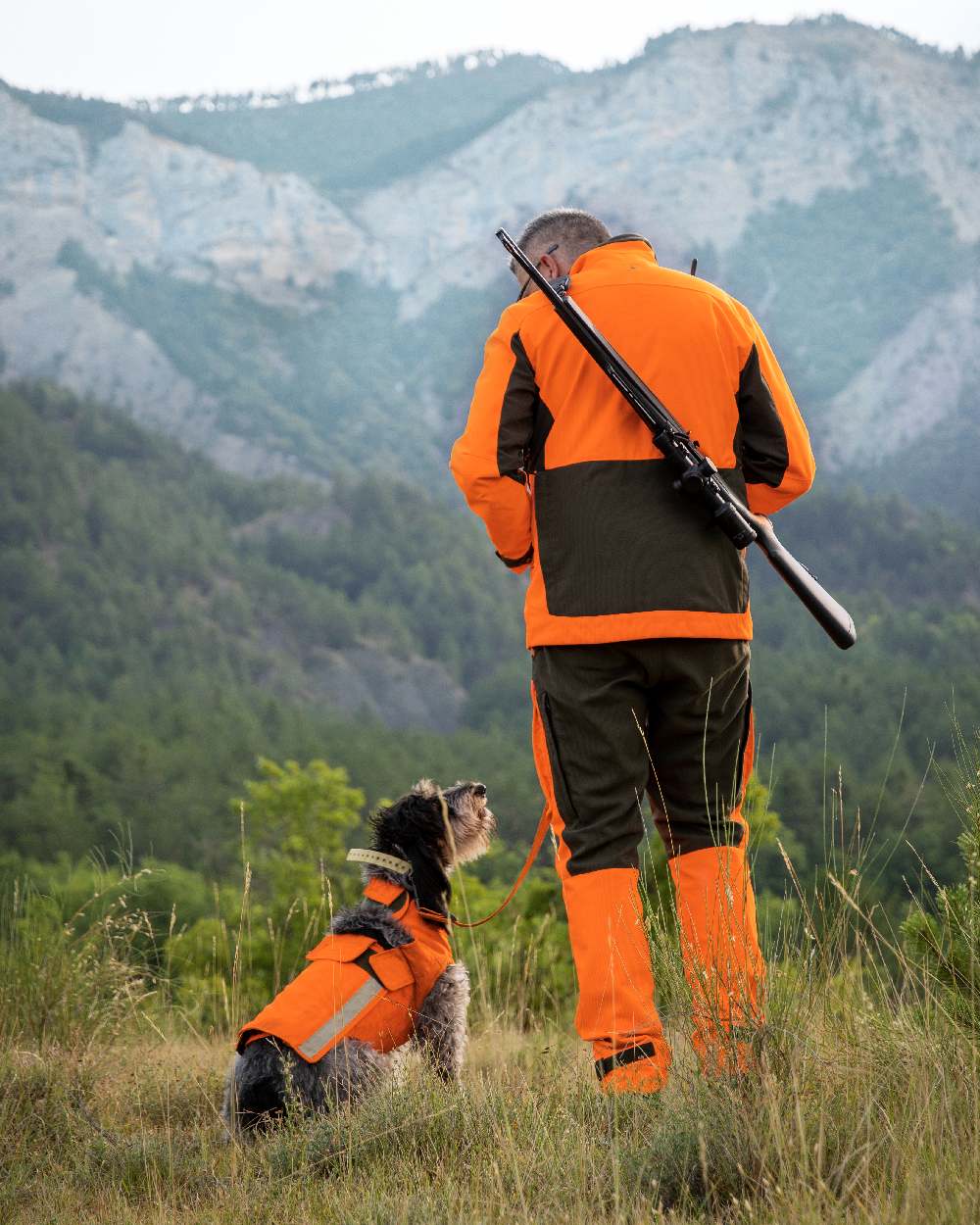Orange coloured Deerhunter Strike Extreme Waterproof Jacket With Membrane on mountain background #colour_orange