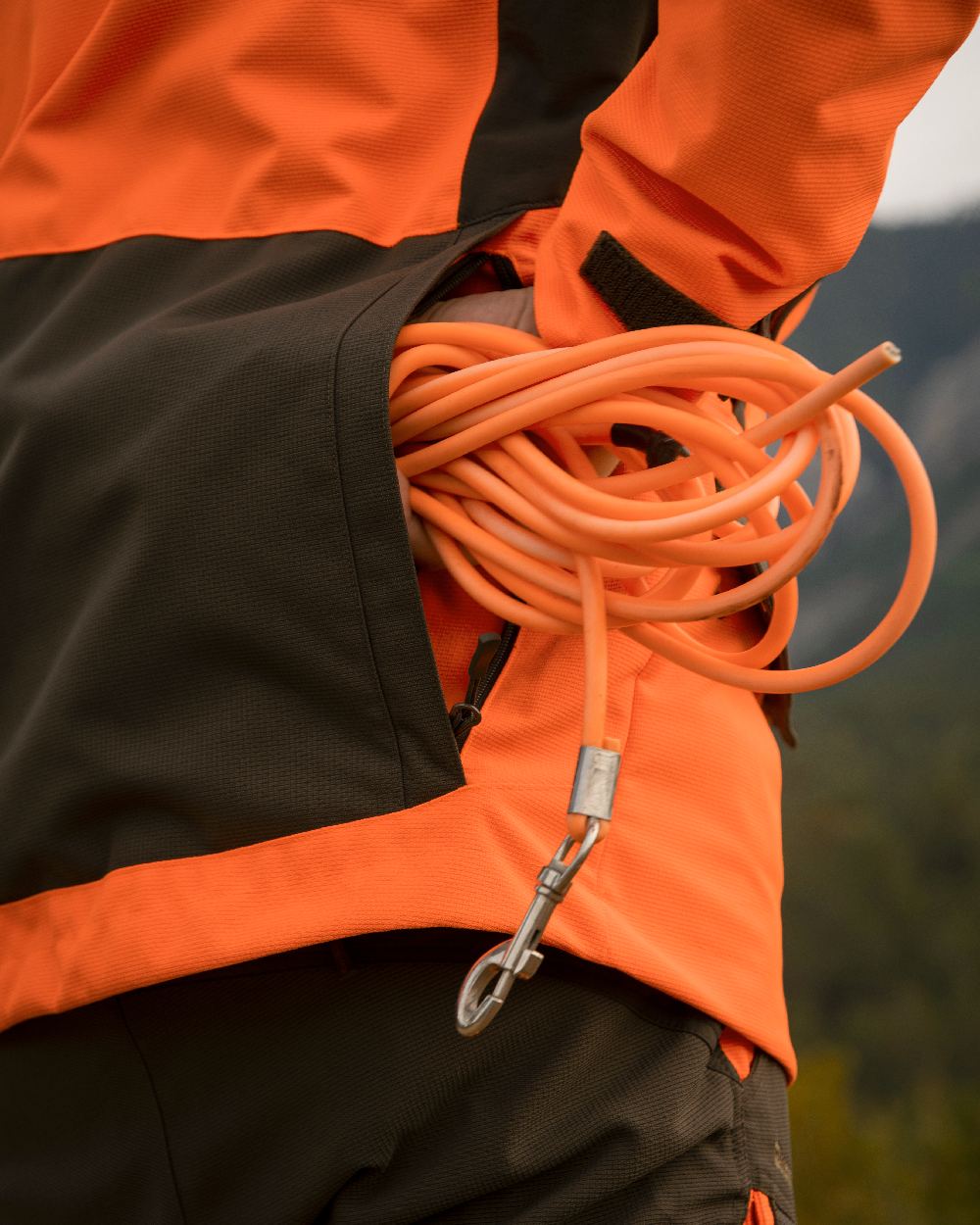 Orange coloured Deerhunter Strike Extreme Waterproof Jacket With Membrane on forest background #colour_orange
