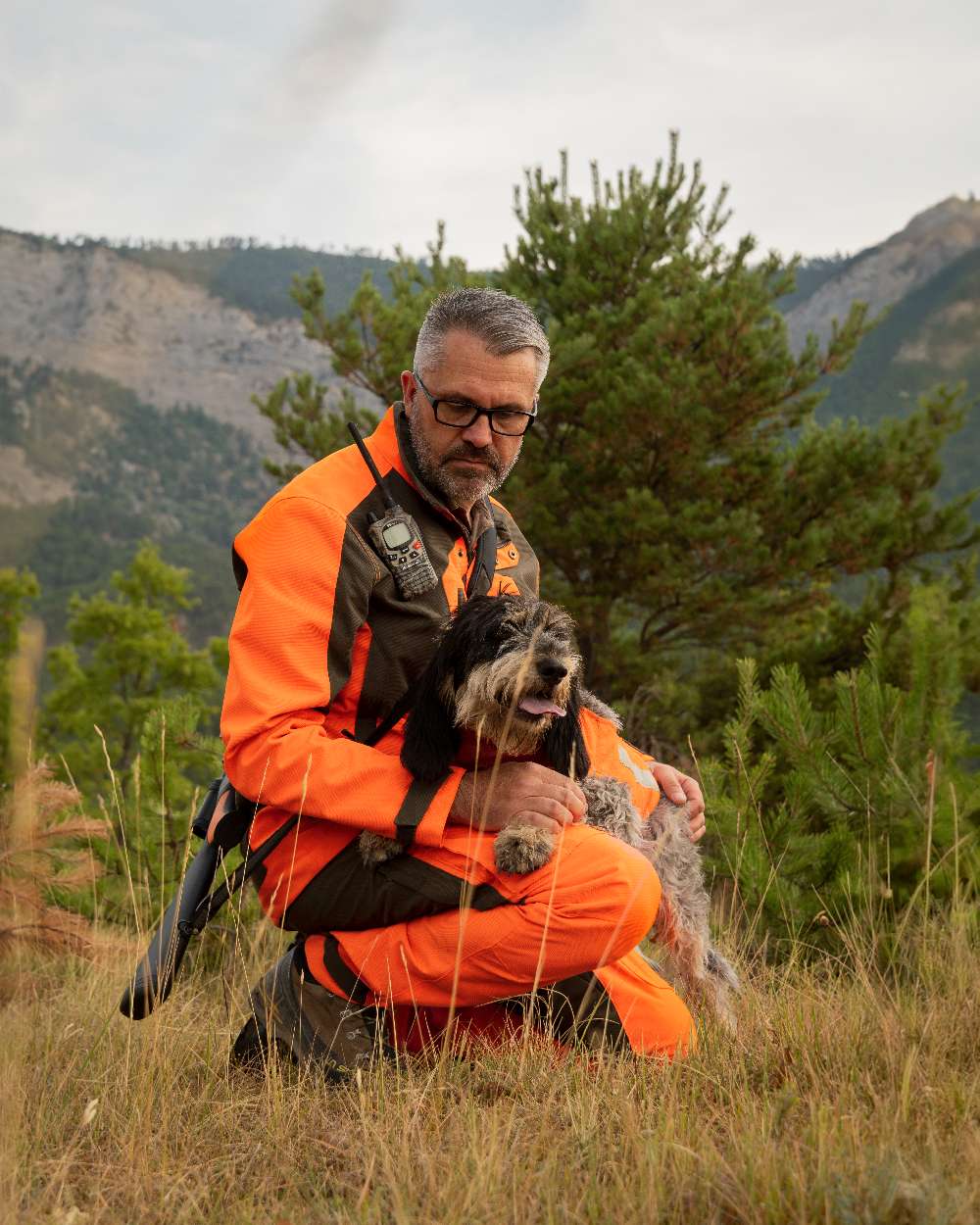 Orange coloured Deerhunter Strike Extreme Waterproof Trousers With Membrane on mountain background #colour_orange