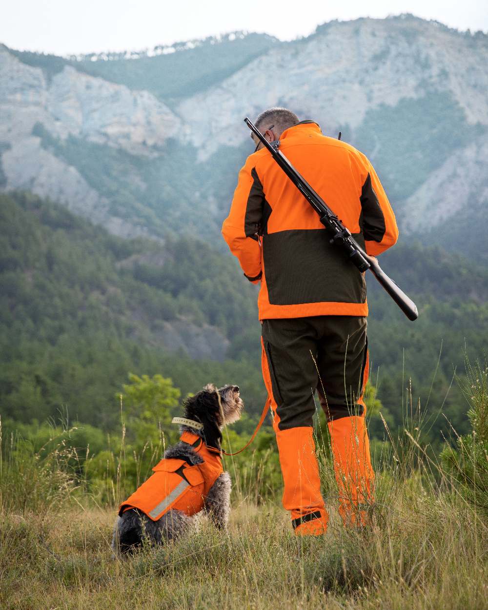 Orange coloured Deerhunter Strike Extreme Waterproof Trousers With Membrane on mountain background #colour_orange