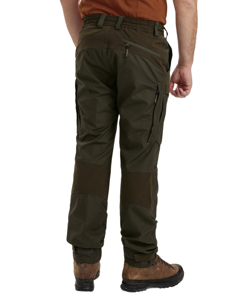 Deep Green coloured Deerhunter Strike Trousers With Membrane on forest background #colour_deep-green