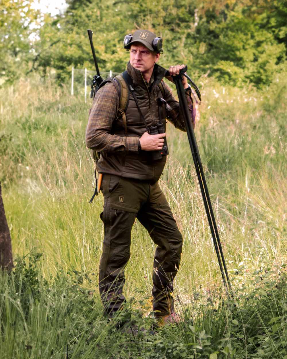 Deep Green coloured Deerhunter Strike Trousers With Membrane on forest background #colour_deep-green
