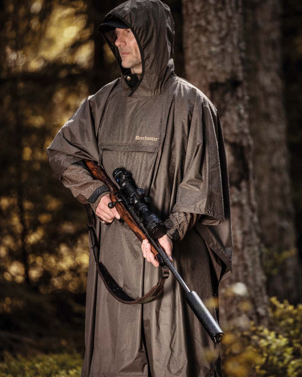 Timber coloured Deerhunter Survivor Rain Poncho on forest background #colour_timber
