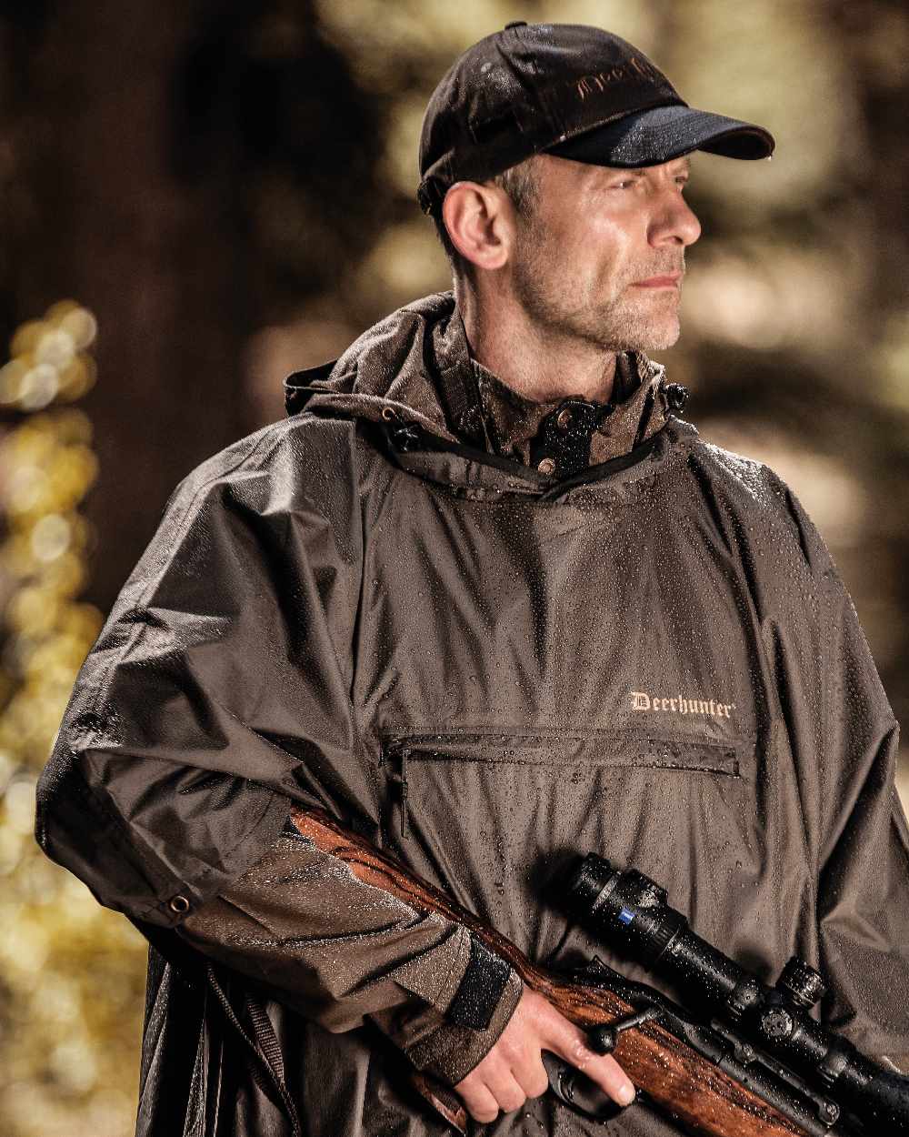 Timber coloured Deerhunter Survivor Rain Poncho on forest background #colour_timber