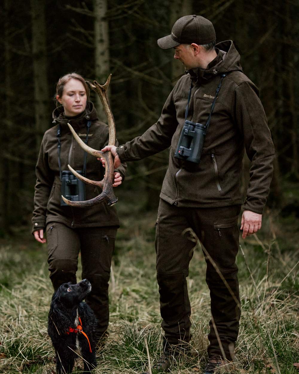 Loden Wood Coloured Deerhunter Tatra Cap With Earflaps On A Forest Background #colour_loden-wood