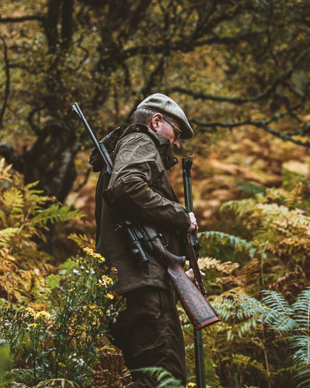 Canteen coloured Deerhunter Track Rain Trousers on forest background #colour_canteen