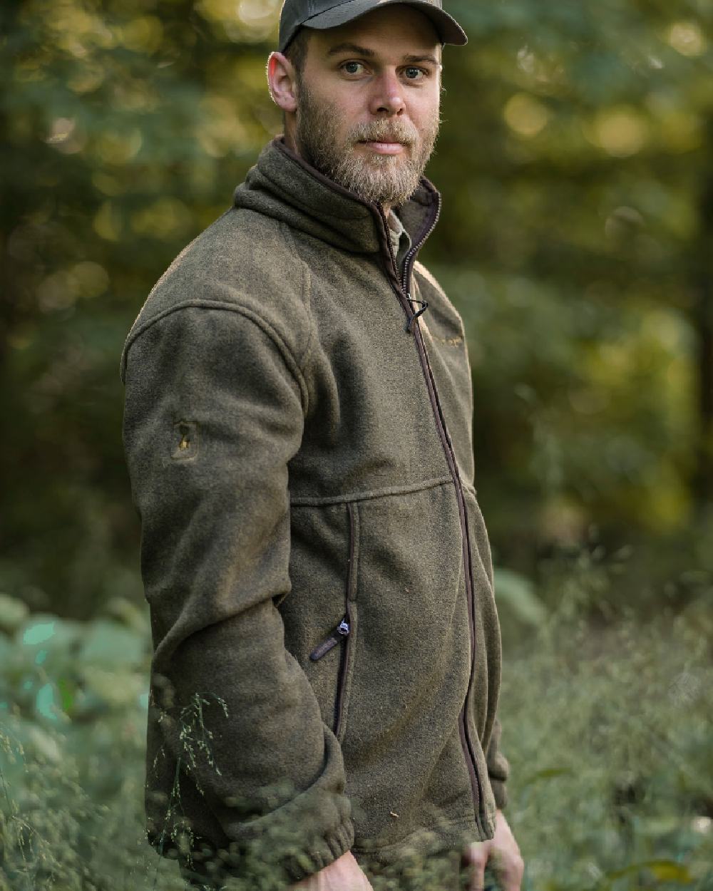 Graphite Green coloured Deerhunter Wingshooter Fleece Jacket on forest background #colour_graphite-green