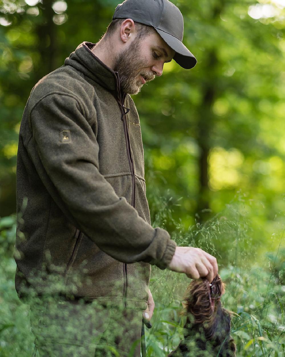 Graphite Green coloured Deerhunter Wingshooter Fleece Jacket on forest background #colour_graphite-green